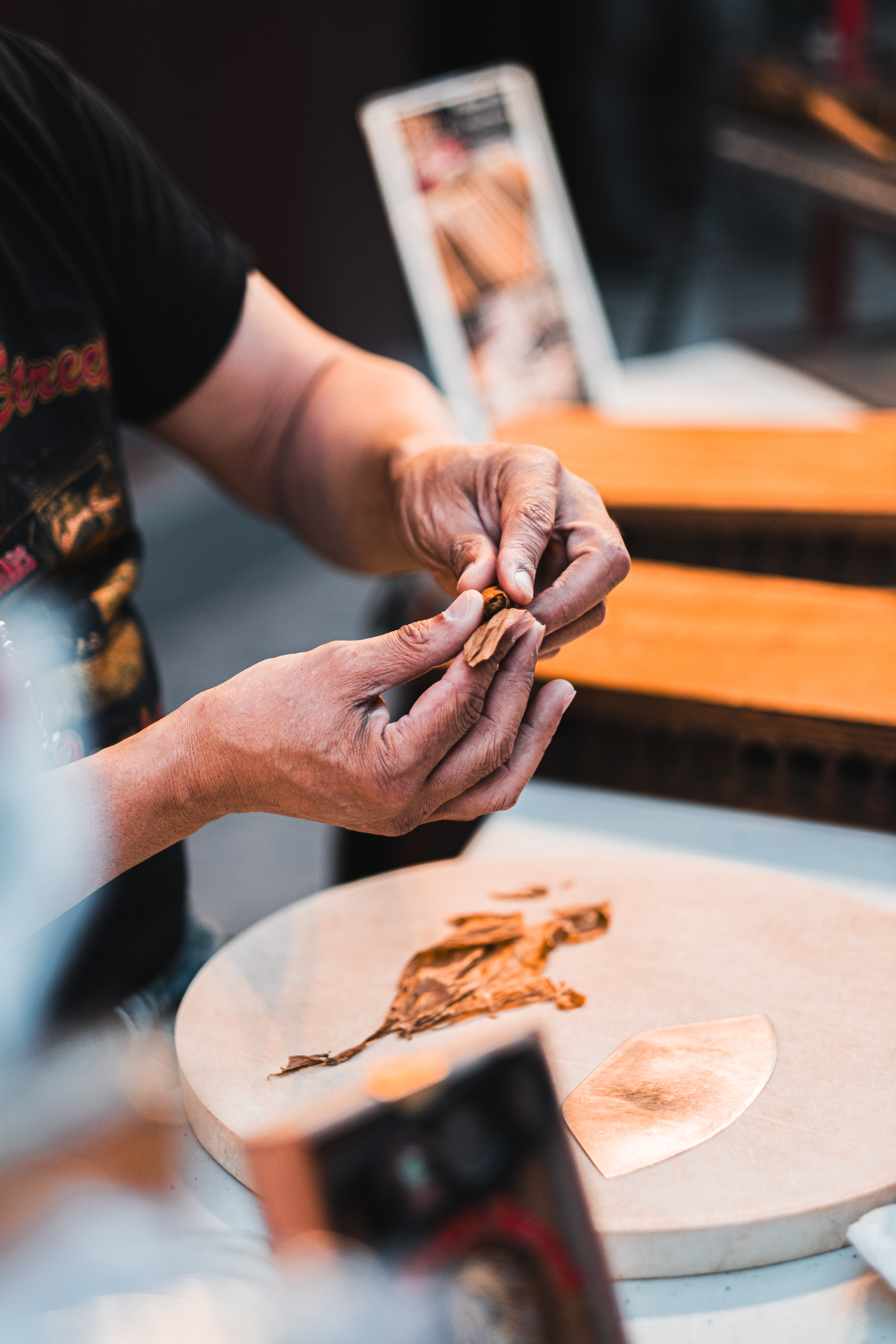 Traditional craftsmanship with hands working on cultural artwork