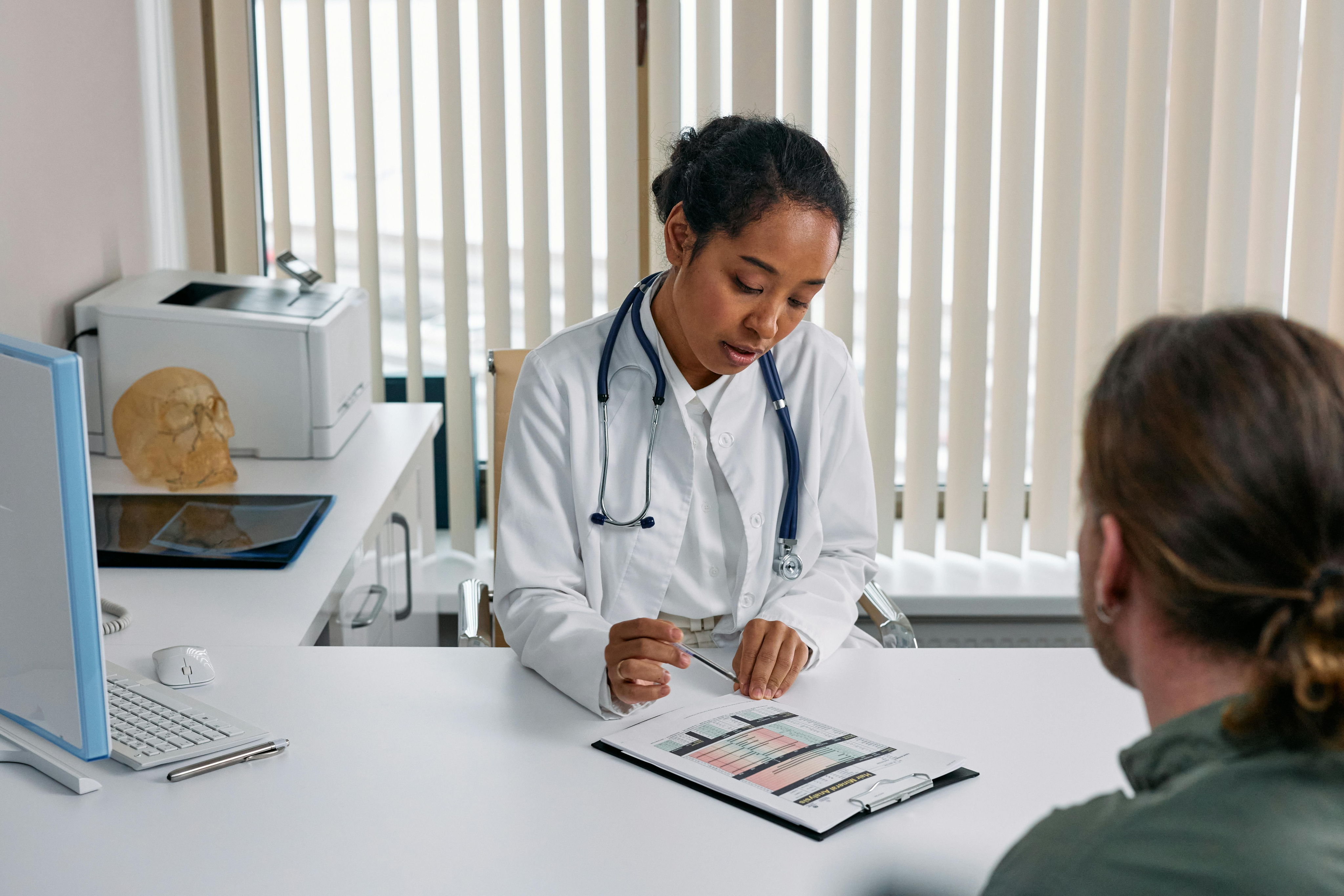Healthcare professional reviewing documents with patient